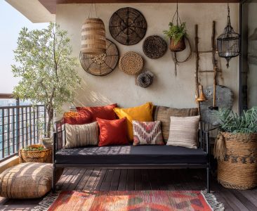 bohemian-balcony-design-with-metal-sofa-and-cane-decor-img
