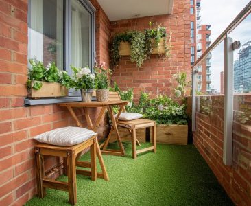 contemporary-balcony-design-with-brick-wall,-artificial-grass-and-plants-img