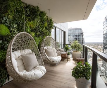 modern-balcony-design-with-modern-green-wall-and-hanging-egg-chairs-img