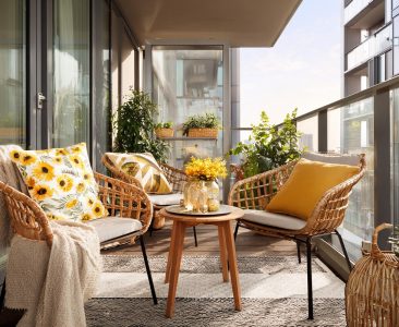 modern-balcony-design-with-wicker-seating-and-sunflower-accents-img